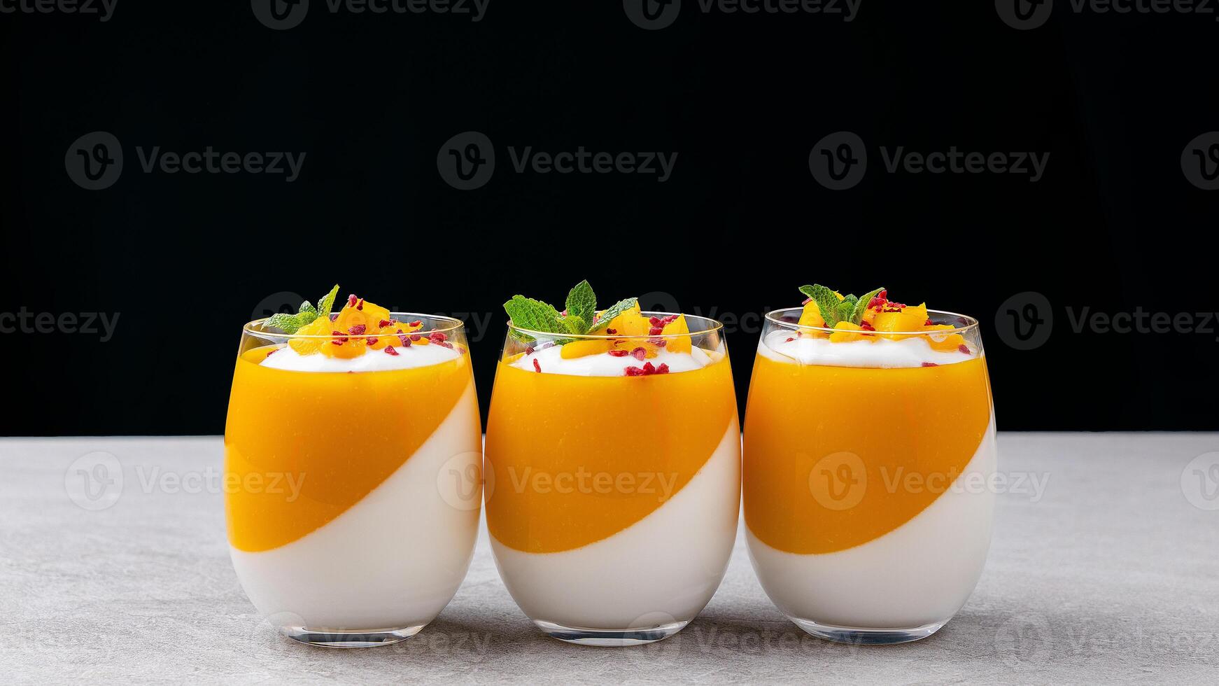 Tangerine panna cotta in a glass on the table photo