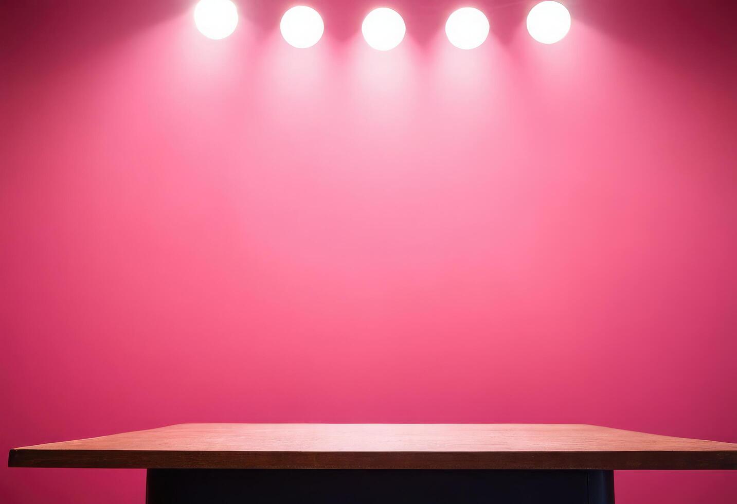 Empty wooden table in front of pink wall with spotlight photo