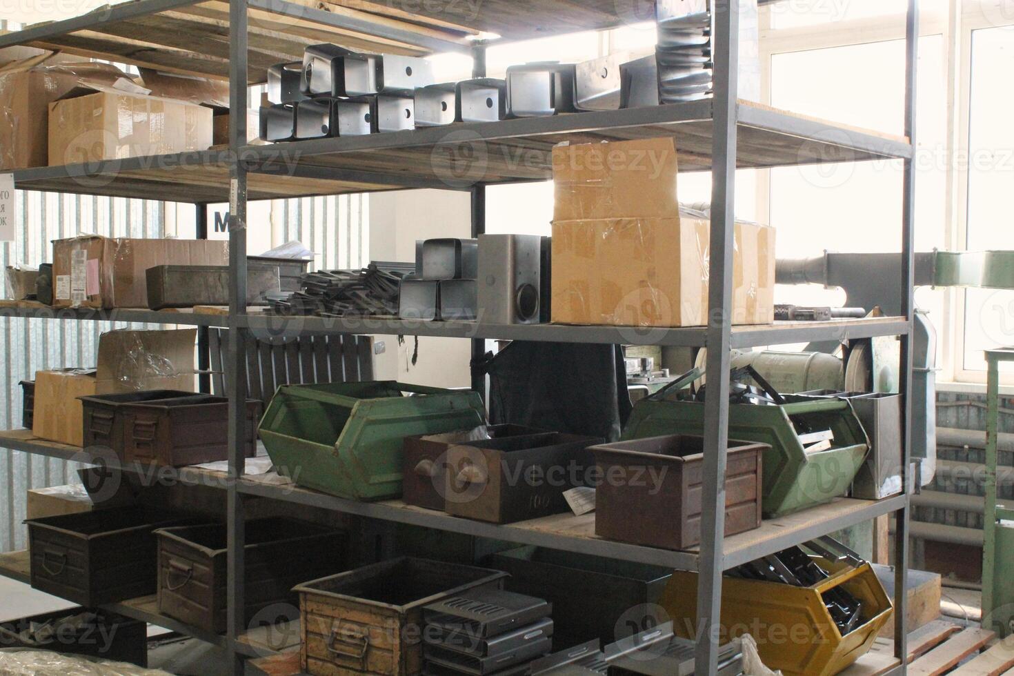 Recycled industrial storage containers on metal shelves. Used plastic and metal bins on racks. Containers for recycling and storage. Storage of recycled materials in box. Sustainable waste management photo