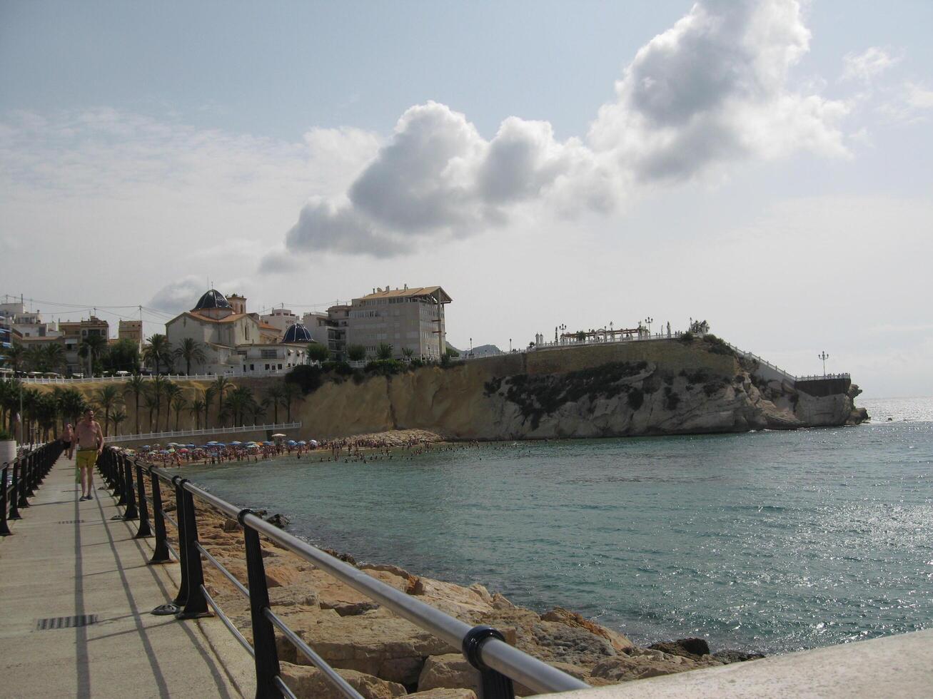Panoramic view of Balcon del Mediterraneo in Costa Blanca on gray autumn sky. Viewpoint from port near Mediterranean sea and beach Mal Pas in Benidorm old town. Benidorm, Spain - September 08, 2008 photo