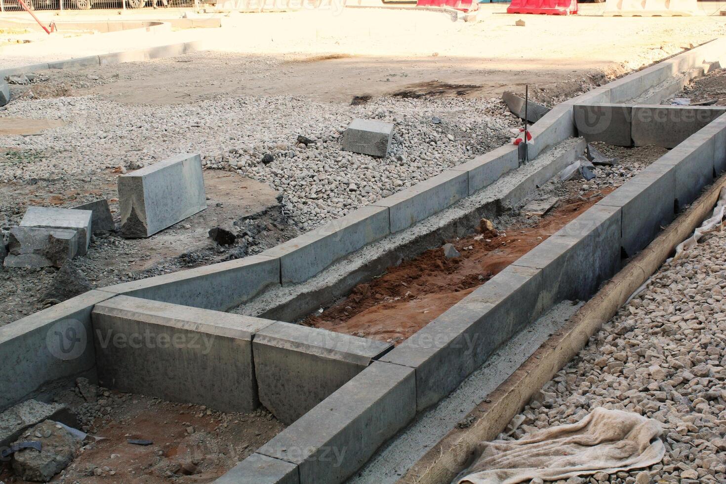New concrete structure at a construction site, with visible gravel and dirt. Infrastructure development and roadwork concept. photo