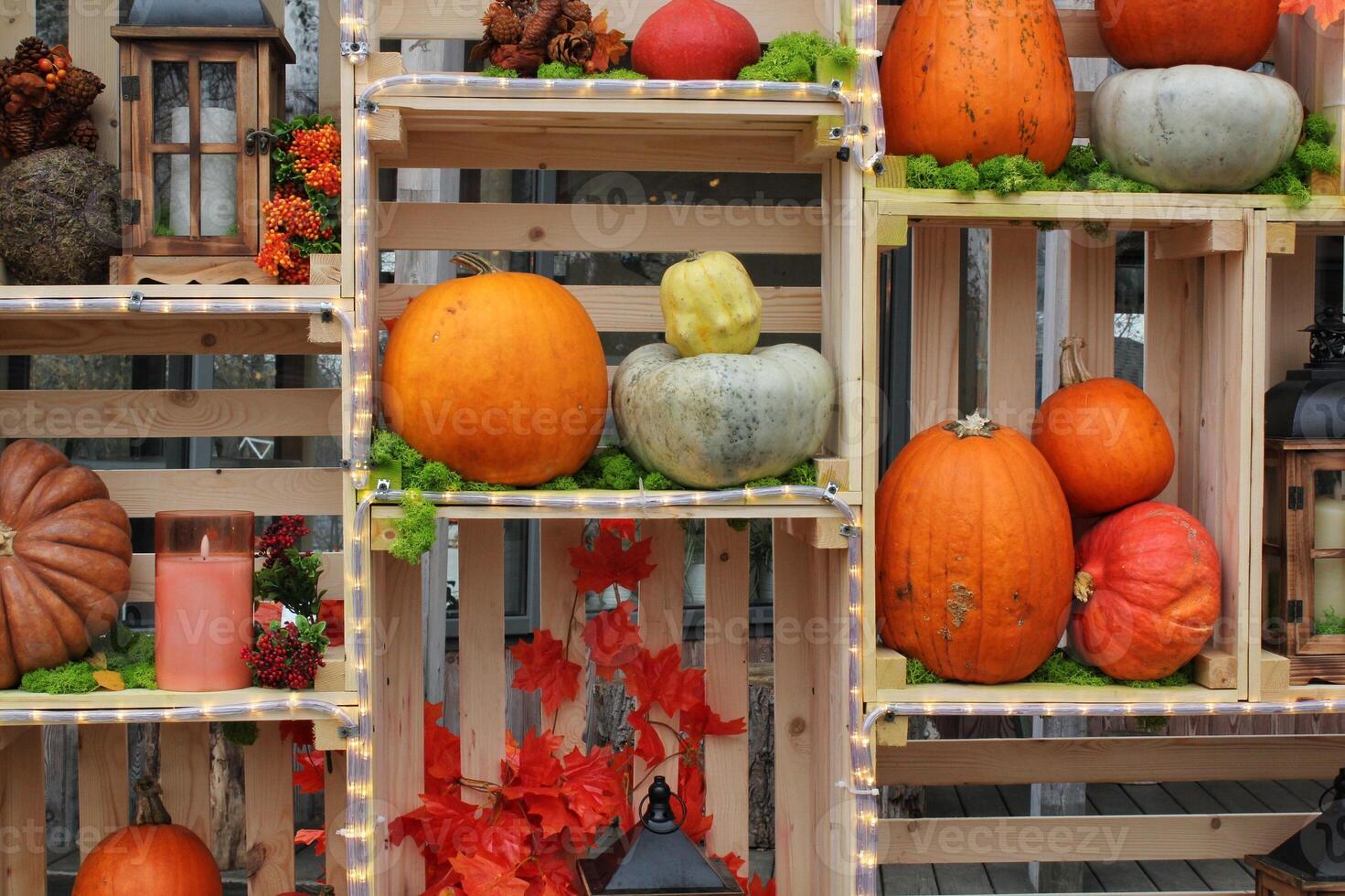 A festive autumn display of pumpkins, gourds, and fall decorations arranged in wooden crates. Rustic and cozy atmosphere. Concept of Thanksgiving and harvest. photo