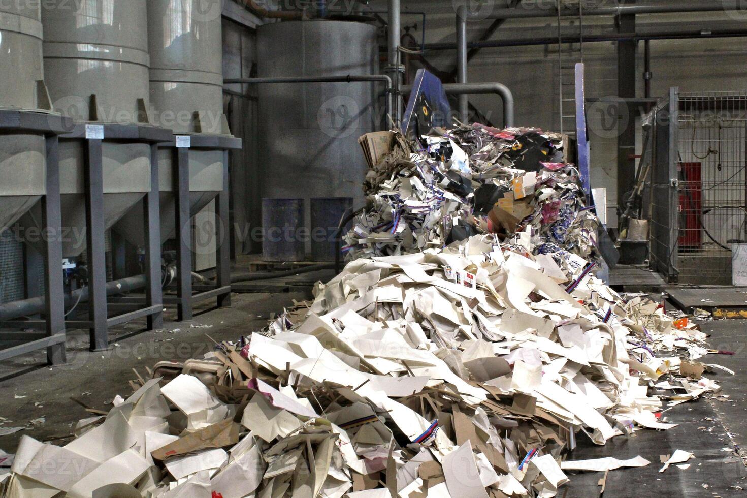 Large pile of shredded paper ready for recycling or disposal. Environmental concept. Pile of waste paper, cardboard and other recyclable materials ready for processing. Recycling and waste management photo