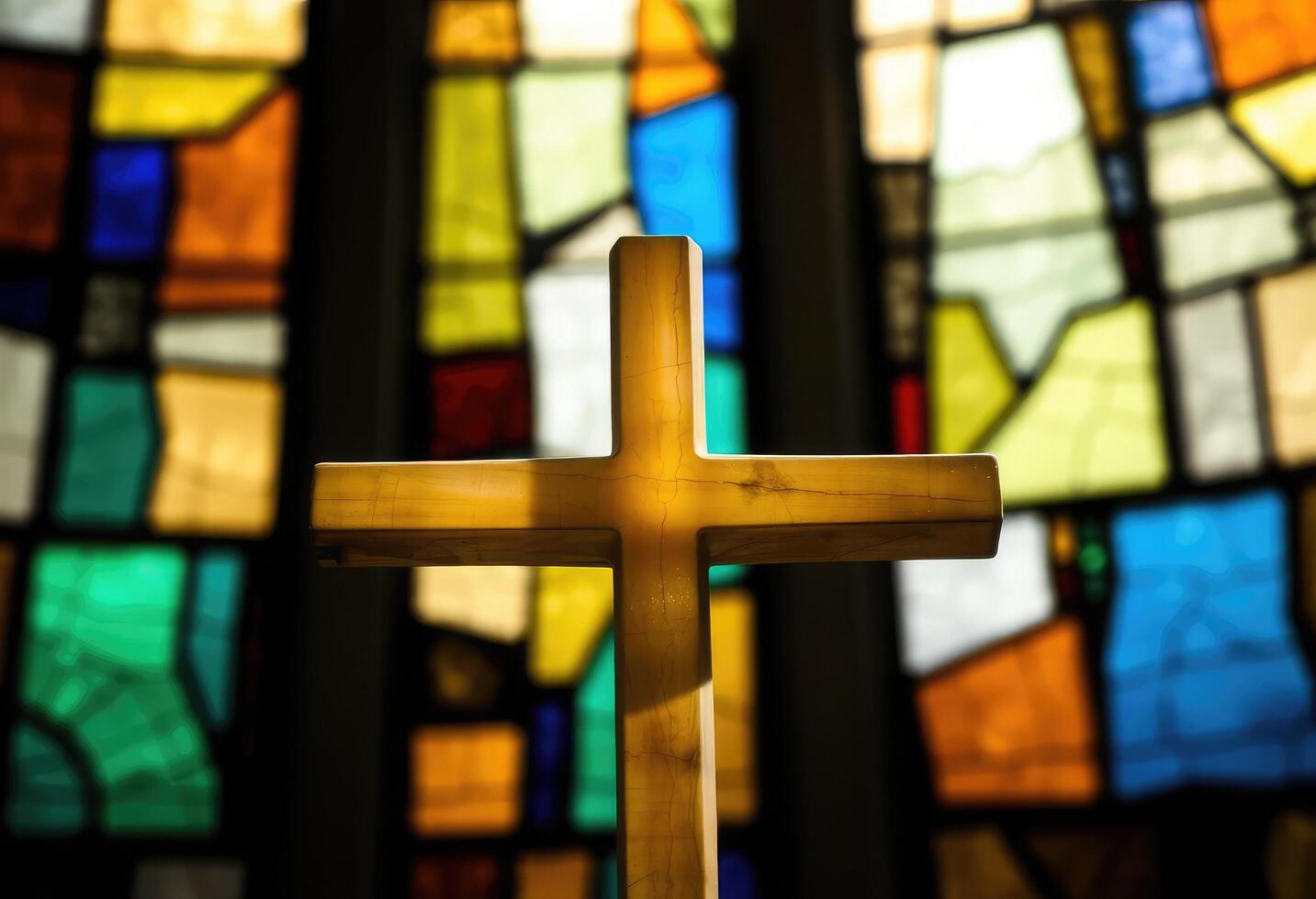 a wooden cross in front of a stained glass window photo