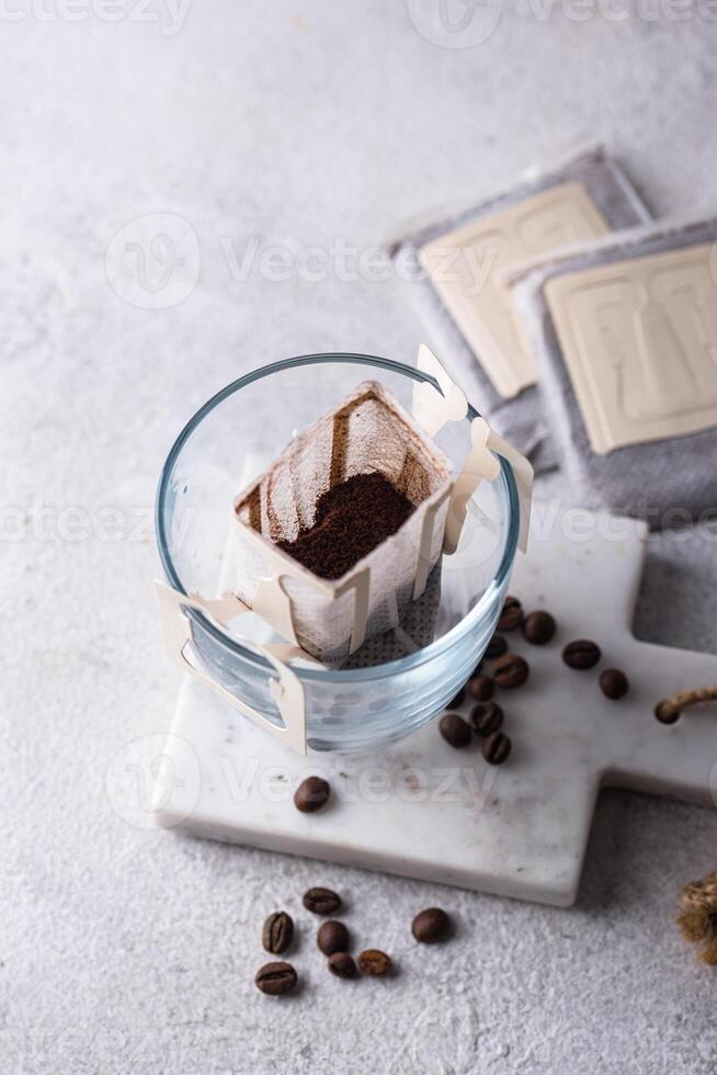 Freshly brewed drip coffee in glass cup photo