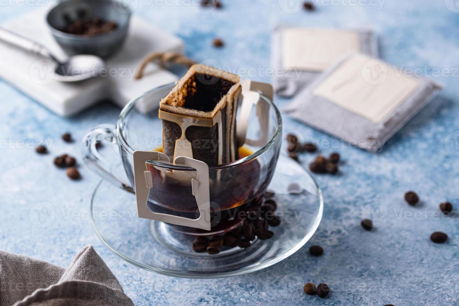 Freshly brewed drip coffee in glass cup photo