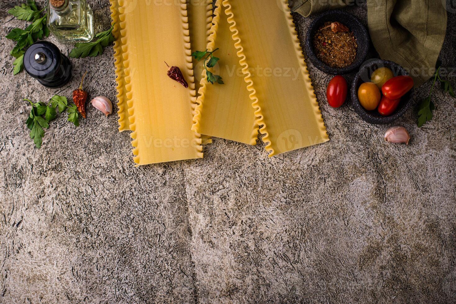 Uncooked lasagna pasta with cooking ingredient photo