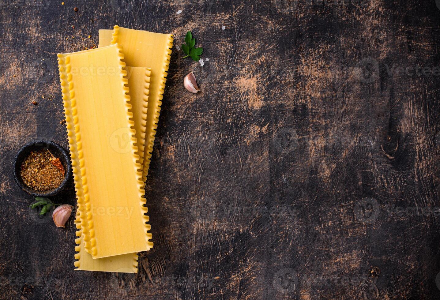Uncooked lasagna pasta with cooking ingredient photo