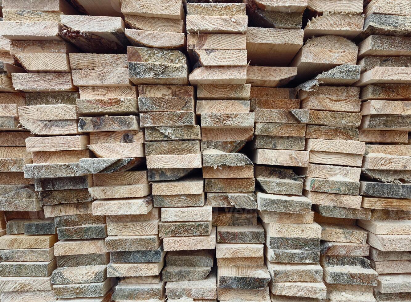 Stacked Wooden Logs Arranged in Neat Horizontal Alignment Close-Up photo