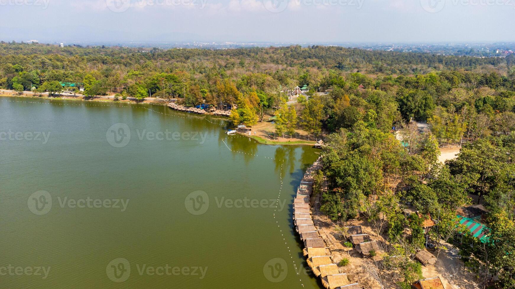 Aerial view of Huay Tueng Thao Reservoir Chiang Mai, showing floating houses and lush forest photo