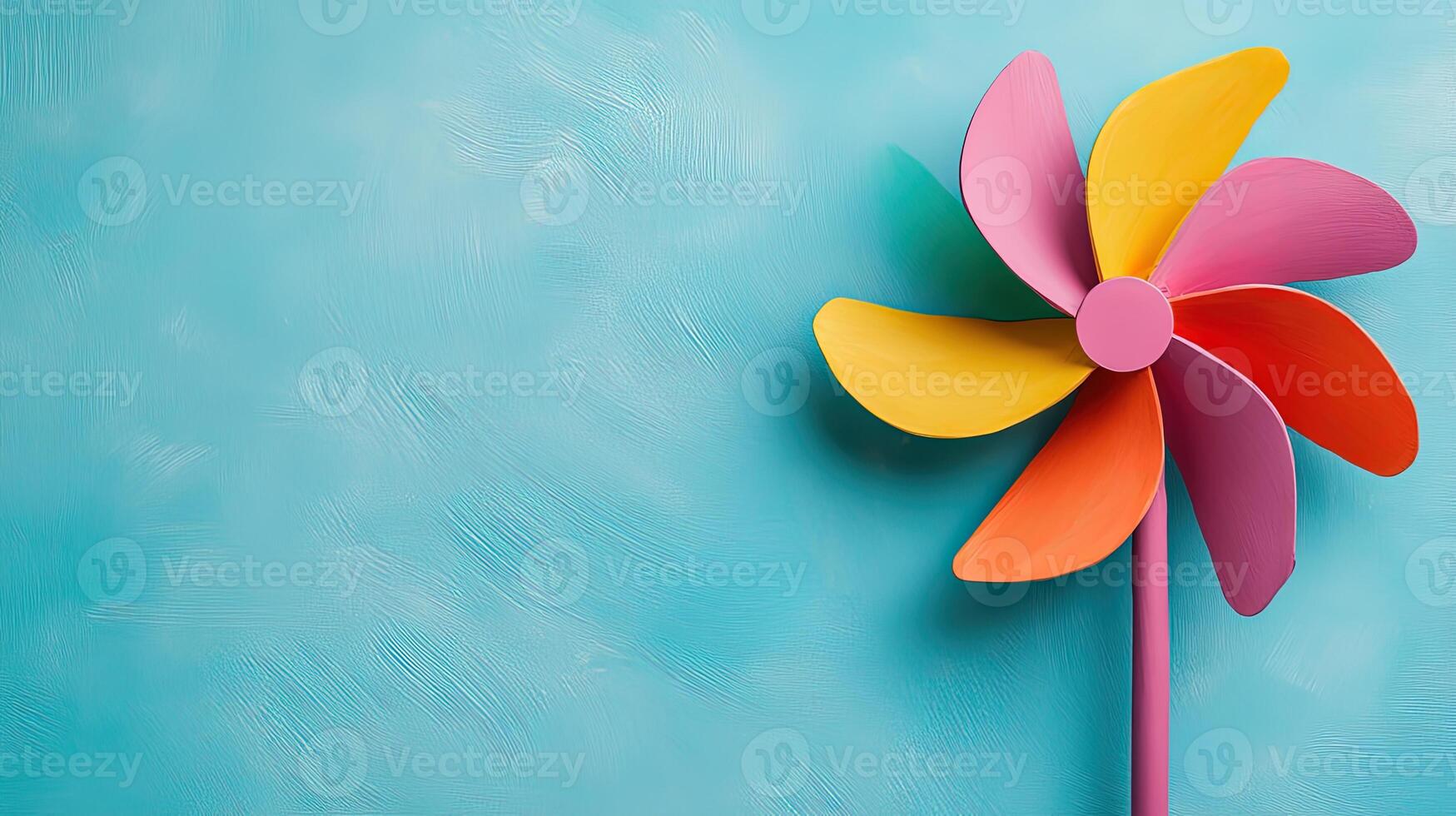 Colorful Pinwheel on Soft Blue Background for Whimsical Vibes photo