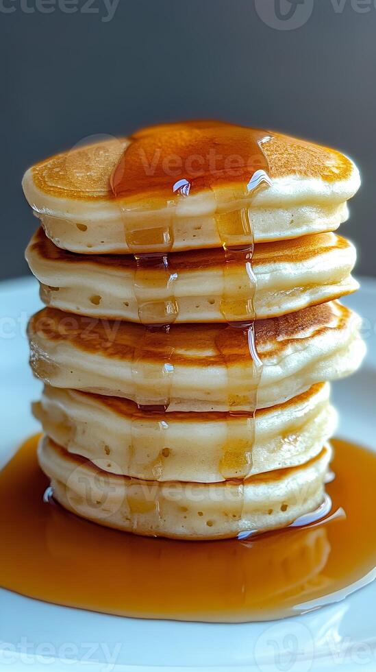 Stack of Delicious Pancakes with Maple Syrup Dripping Down photo