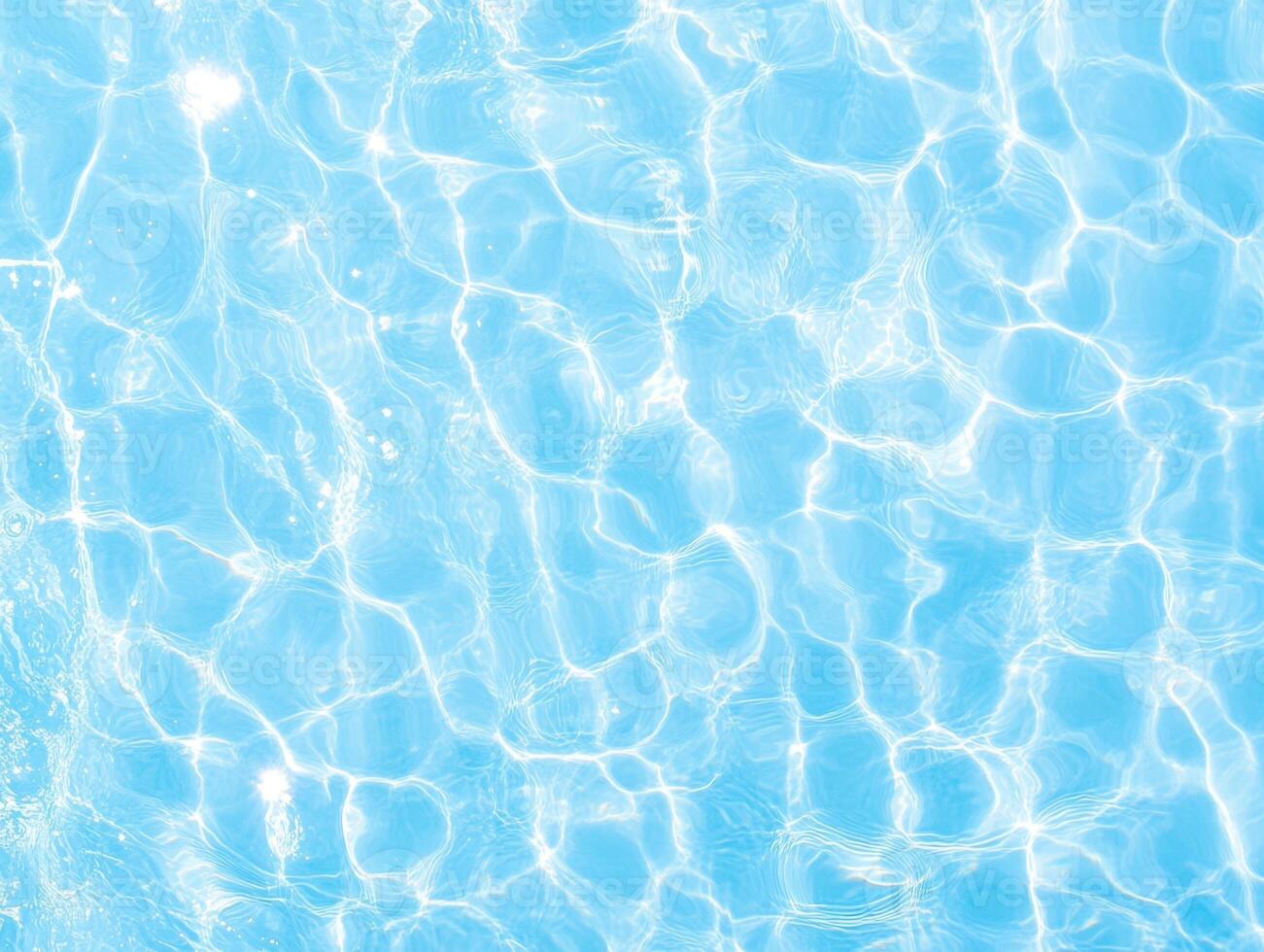 Serene light blue water surface with vibrant sun-dappled reflections. Gentle ripples create pattern photo