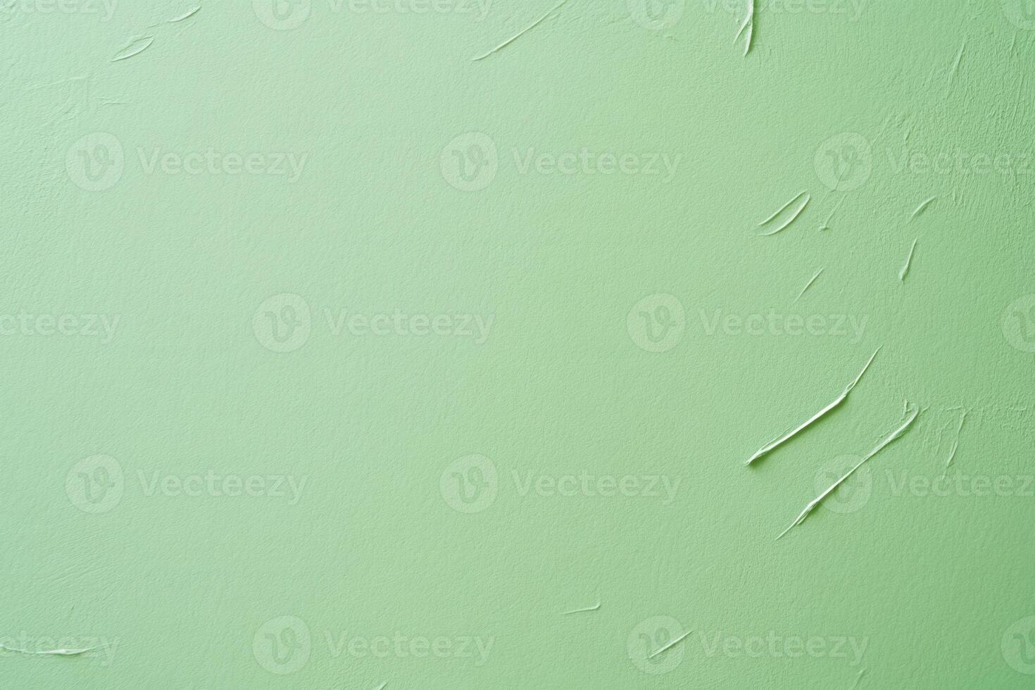 Textured light green wall with streaks of white, creating depth and subtle visual interest photo