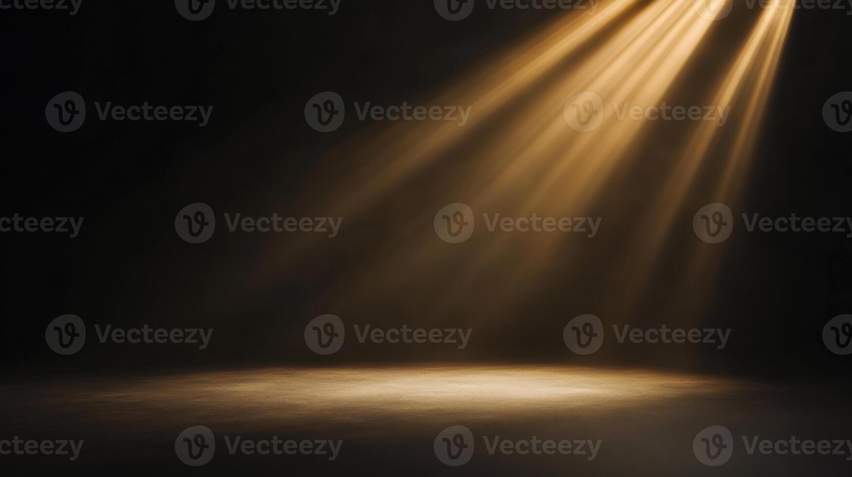 Dramatic golden light beams illuminating a stage floor creating a stark contrast in the dark photo
