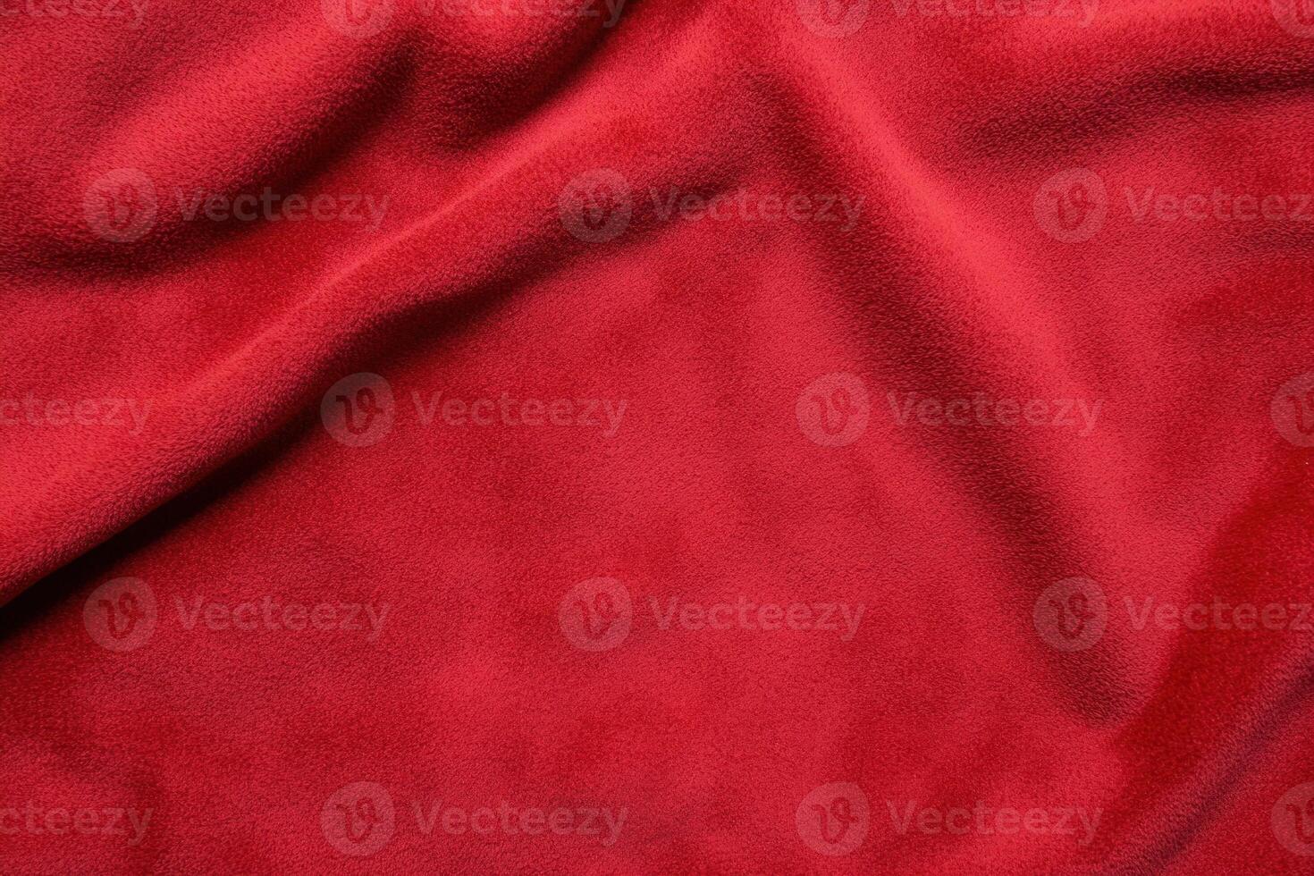 Red fabric with soft texture and gentle folds, creating a warm and inviting abstract pattern photo