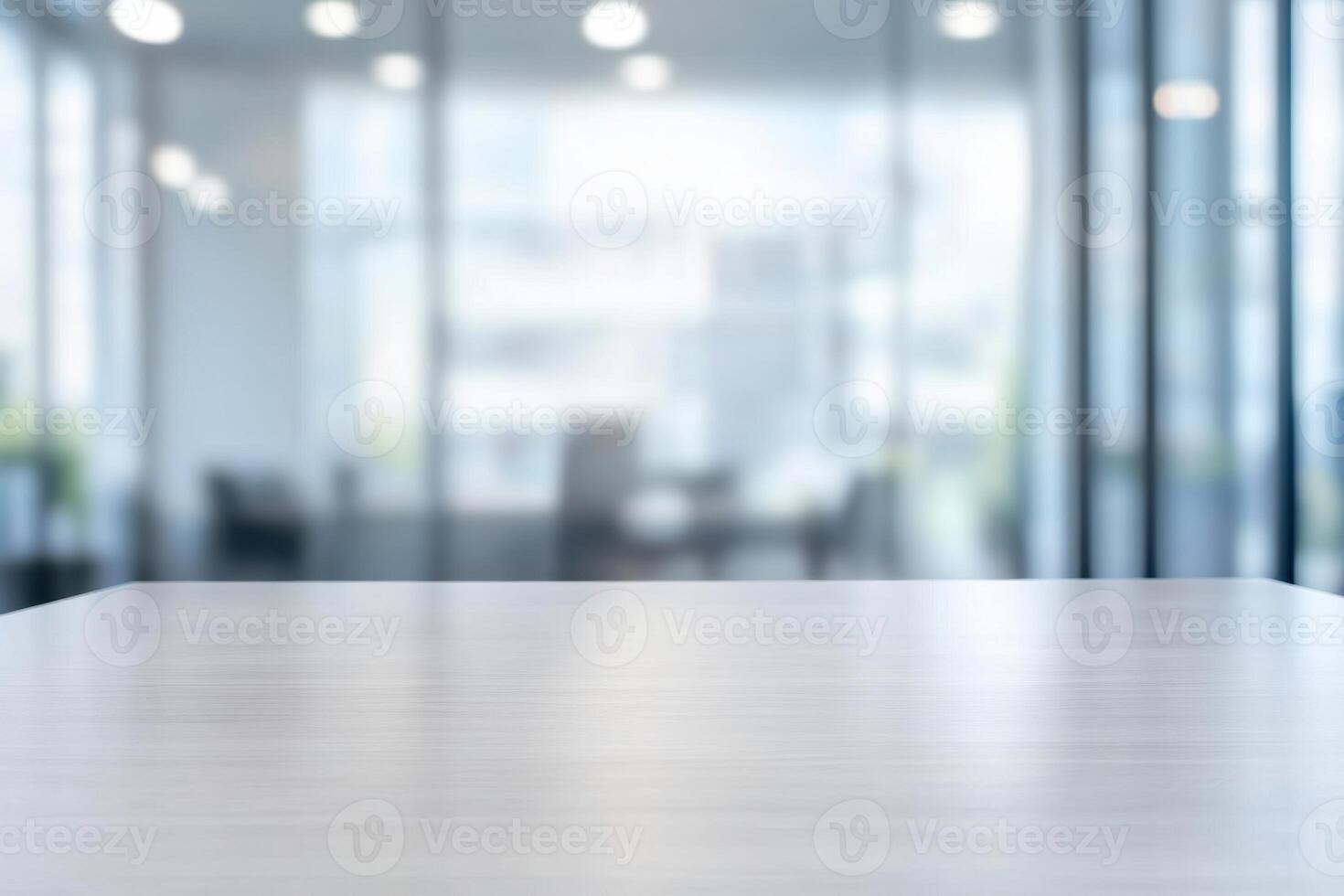 Minimalist office space with a bright, blurred background and a clean, empty desk in the foreground photo