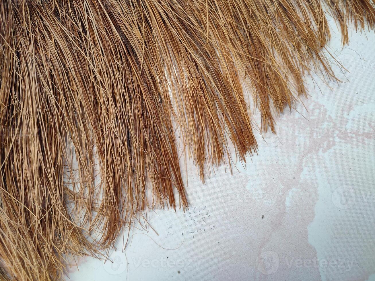 a close up of a straw hat on a white surface photo