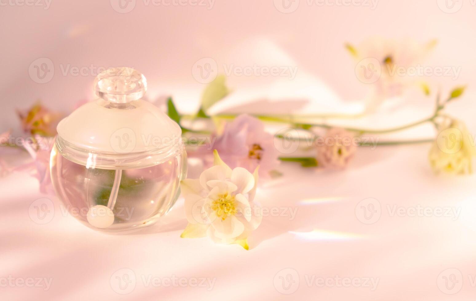 Elegant Perfume Bottle with Flowers on Soft Background photo
