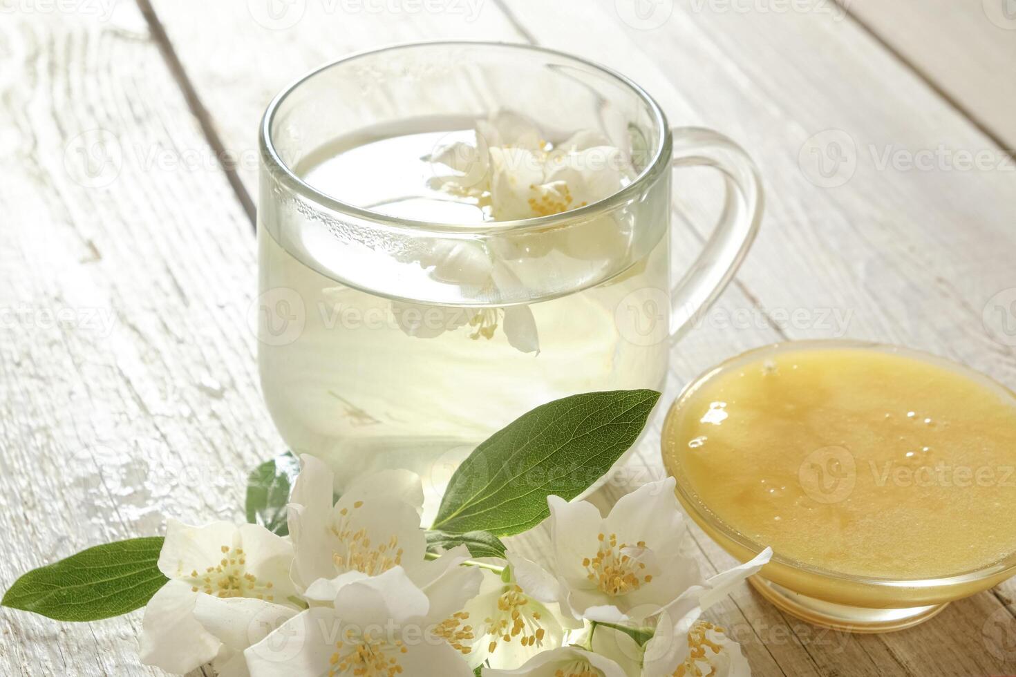 Jasmine Tea with Honey on Rustic Wooden Table photo