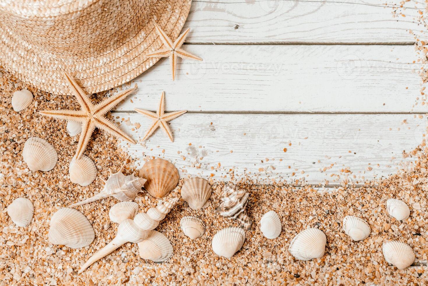Sand seashells background. Summer time concept with sea shells and starfish on wooden background and sand photo