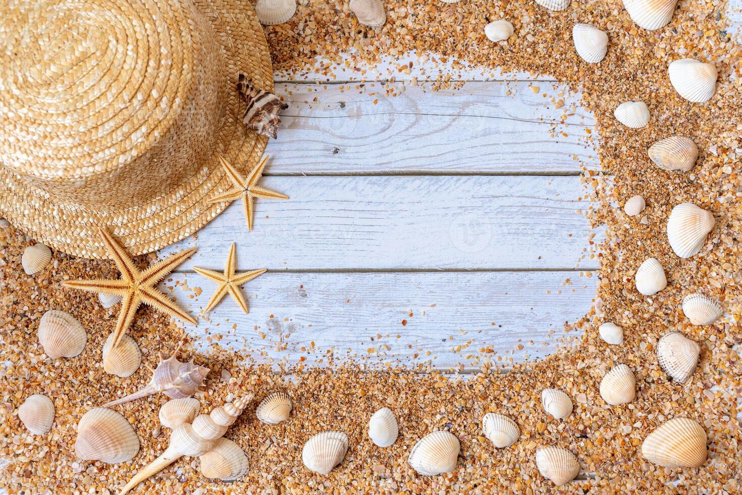 Sand seashells background. Summer time concept with sea shells and starfish on wooden background and sand photo