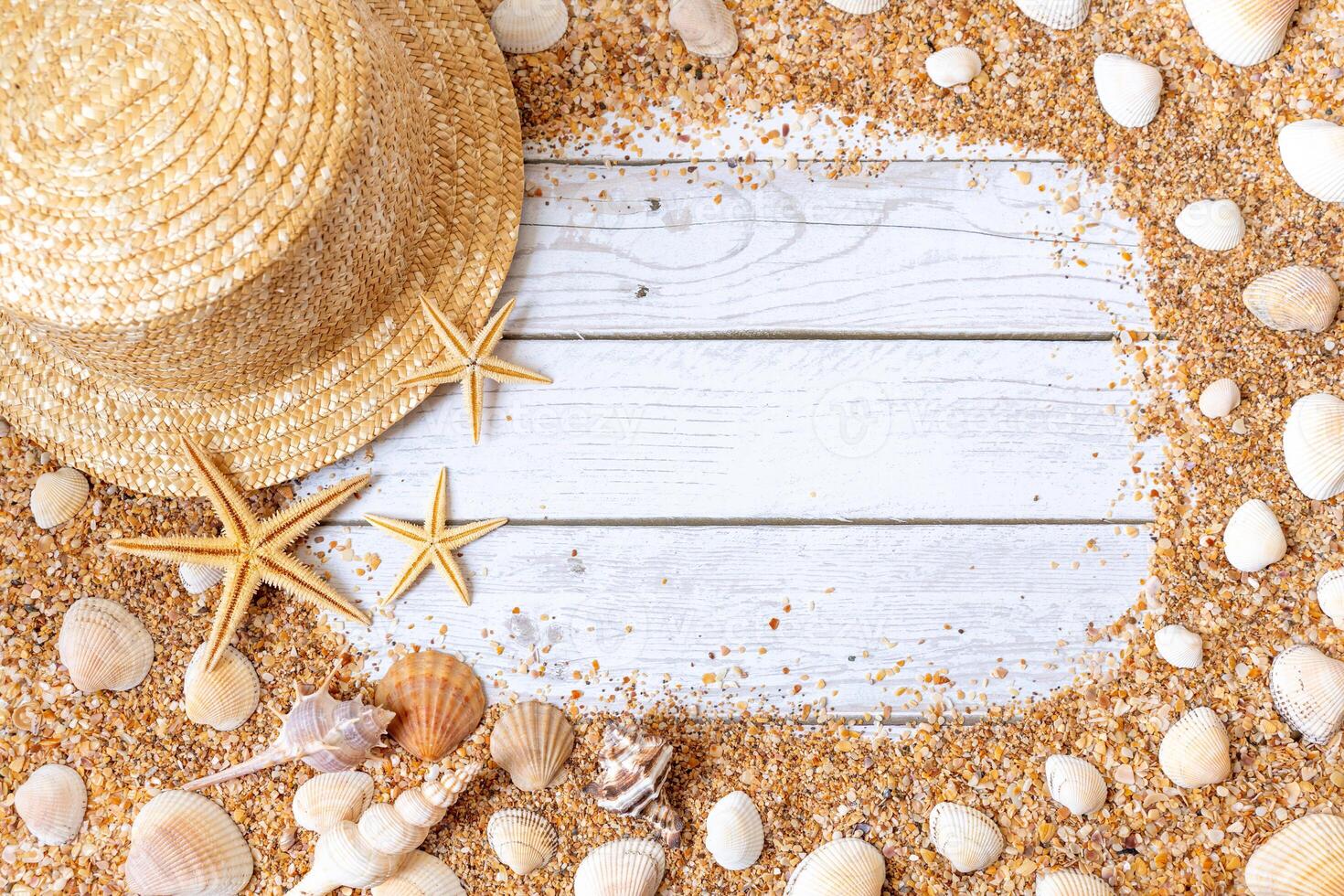 Sand seashells background. Summer time concept with sea shells and starfish on wooden background and sand photo