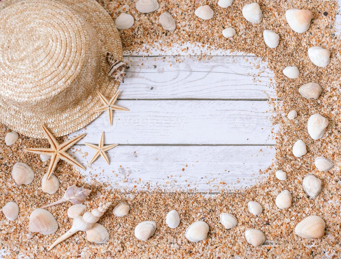 Sand seashells background. Summer time concept with sea shells and starfish on wooden background and sand photo