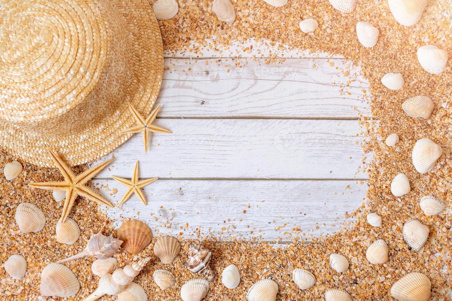 Sand seashells background. Summer time concept with sea shells and starfish on wooden background and sand photo