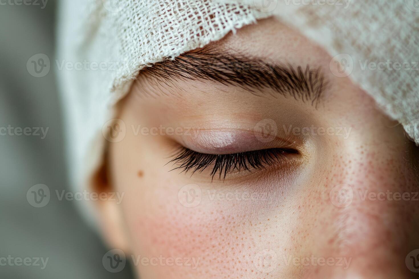 A close up of a woman's eye with a bandage photo