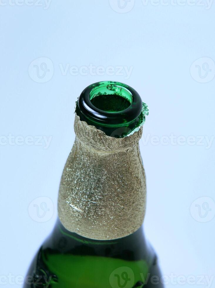 Open Beer bottle close-up on blue background photo