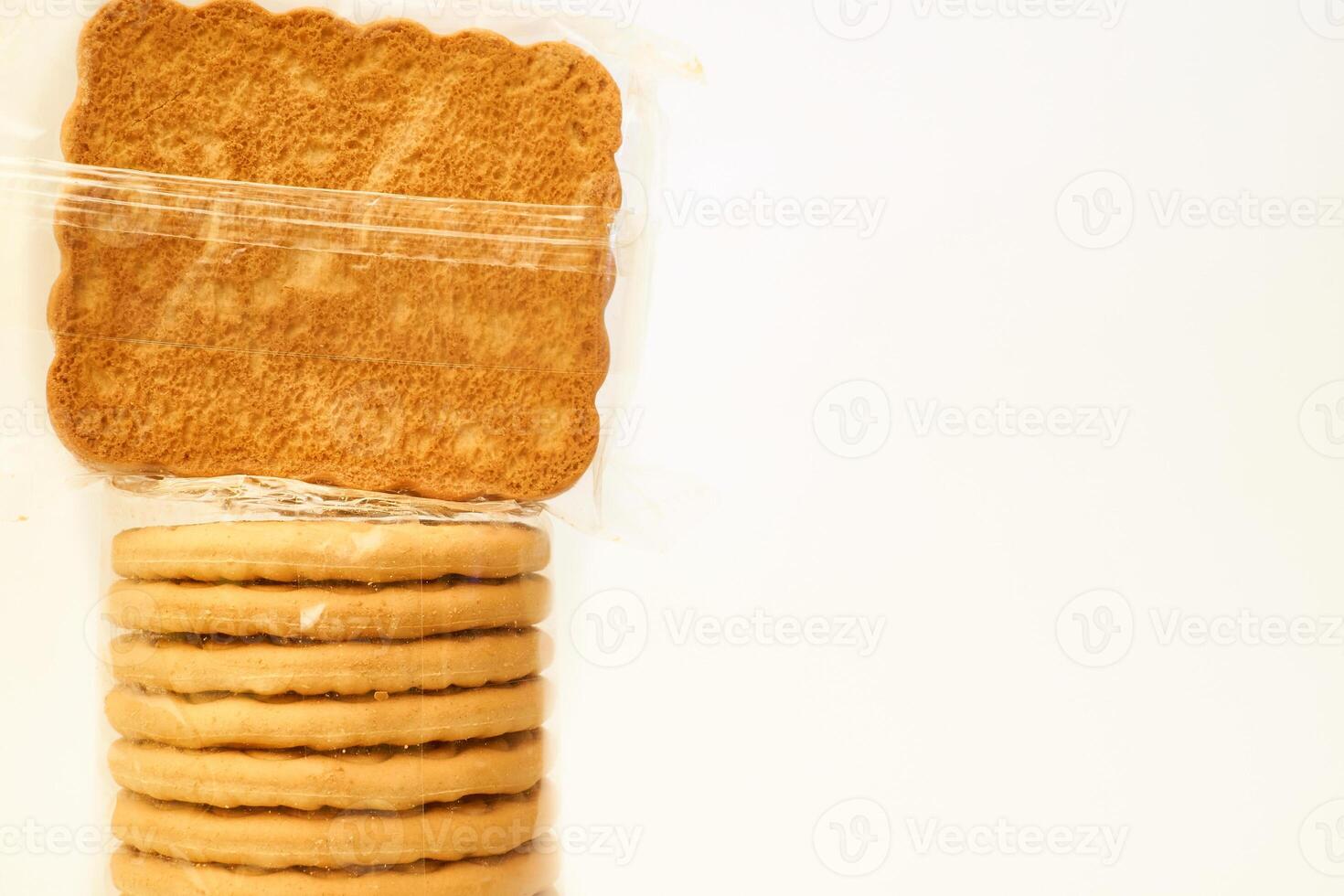 Tasty cookies in a protective cellophane package for sale on a white photo