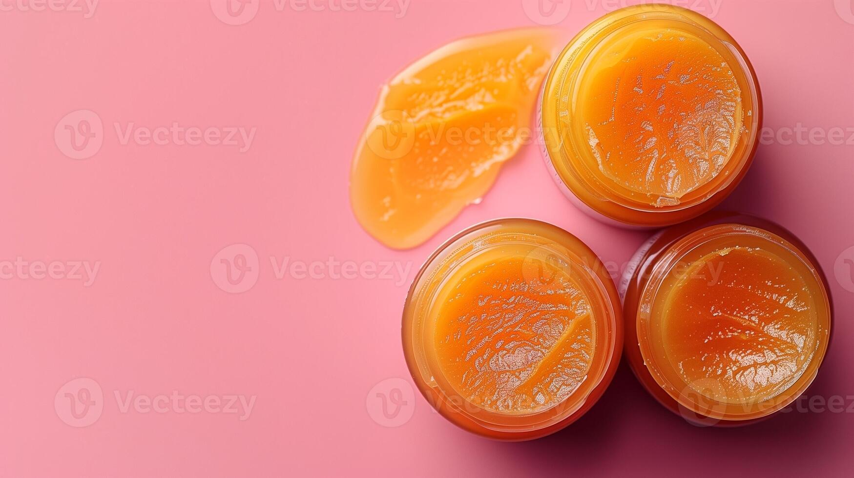 Balm jars with a golden spread on a soft pink background creating a warm and inviting scene photo
