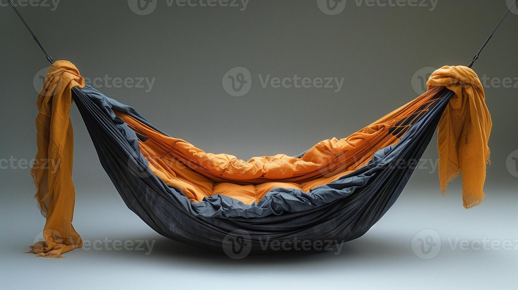 A cozy hammock with a combination of orange and gray fabric suspended in mid-air photo