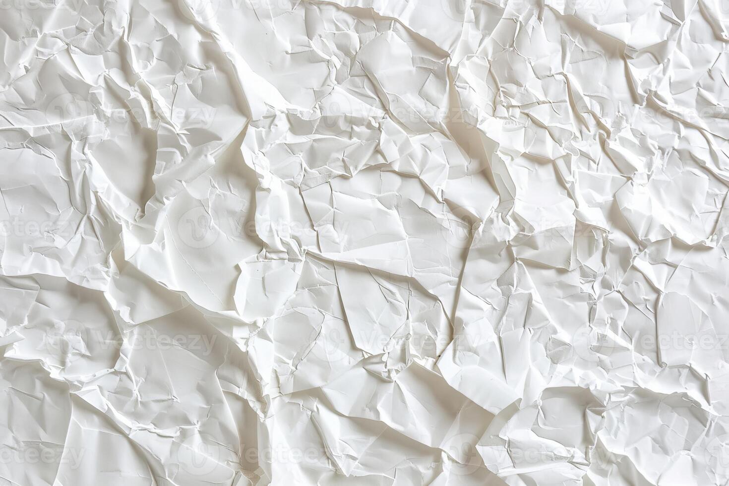 Crumpled white paper showcases intricate textures and shadows, perfect for adding depth to artistic designs or craft projects photo
