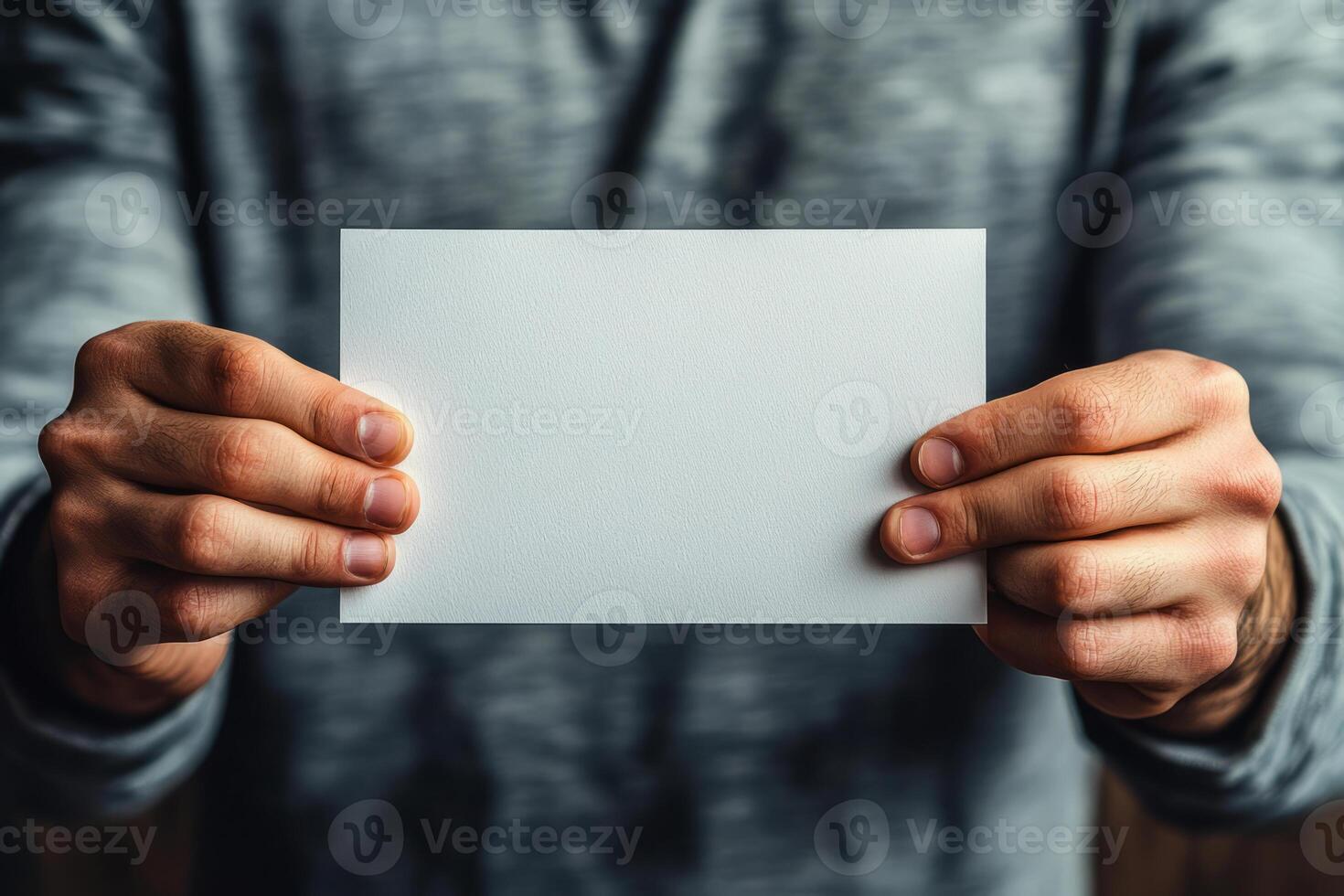 Man Holding Blank White Card in Hands photo