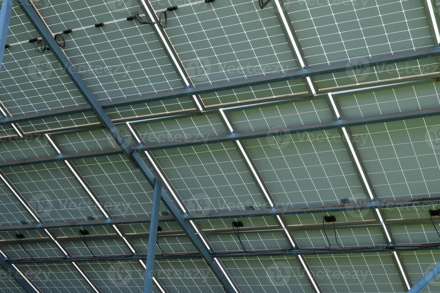 Solar panels glistening under the sun, reflecting sustainable energy solutions above a modern building photo
