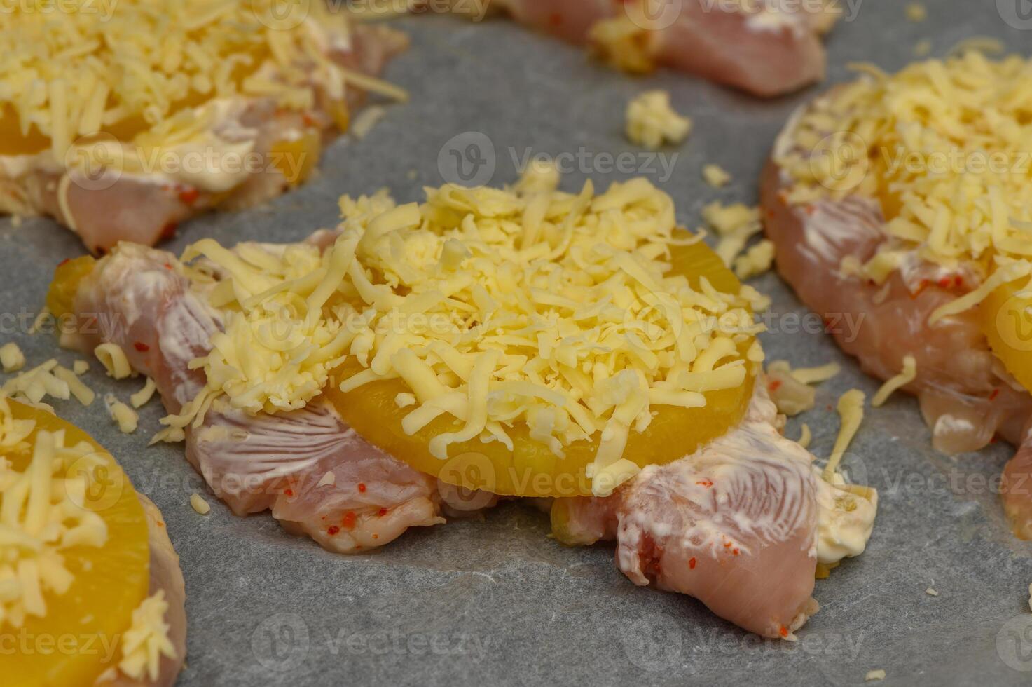 Juicy chicken topped with pineapple and cheese ready for baking in a cozy kitchen photo