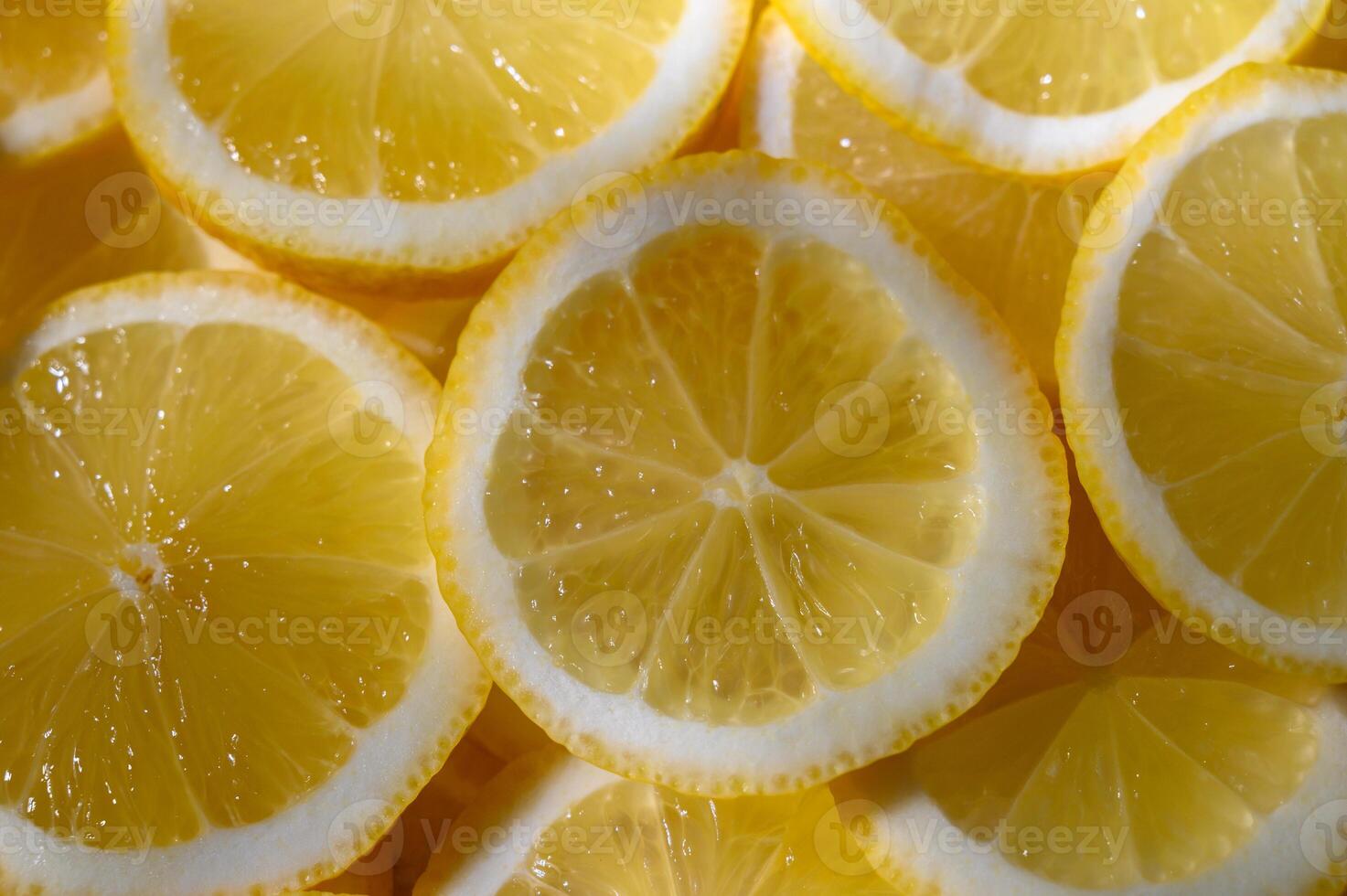 Bright slices of lemon arranged in a vibrant, refreshing pattern for culinary inspiration photo