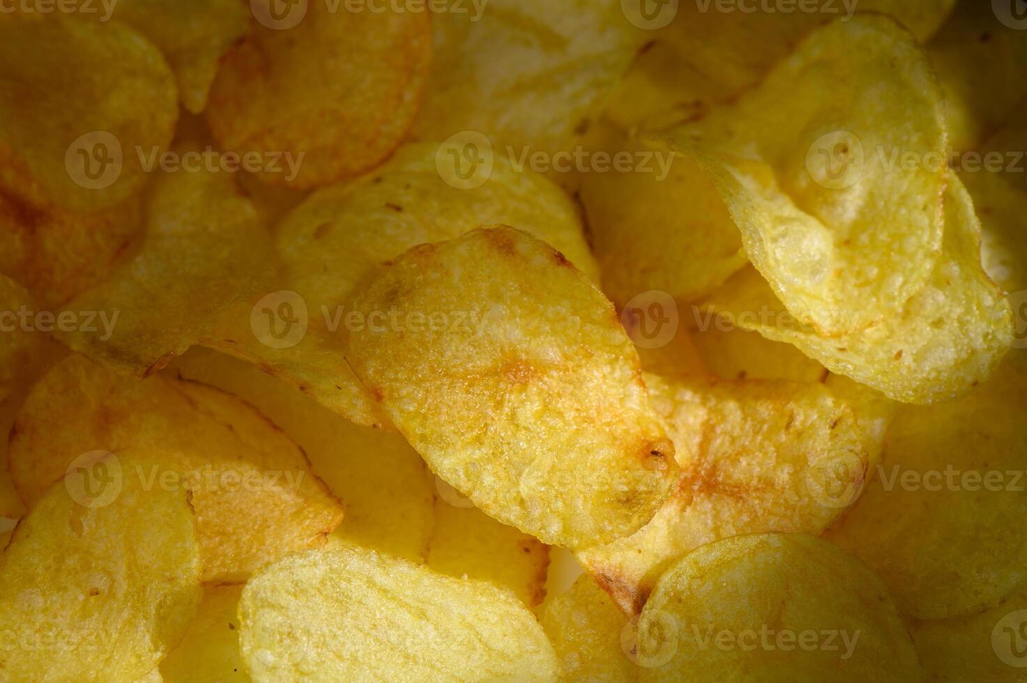 Crunchy golden potato chips filling bowl perfect for sharing during movie night photo