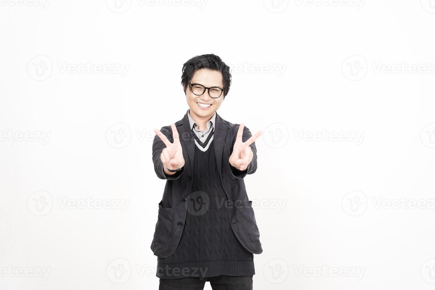 A man in glasses and a sweater is making a peace sign photo