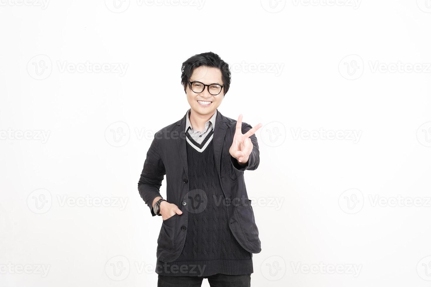 A man in glasses and a sweater is making a peace sign photo