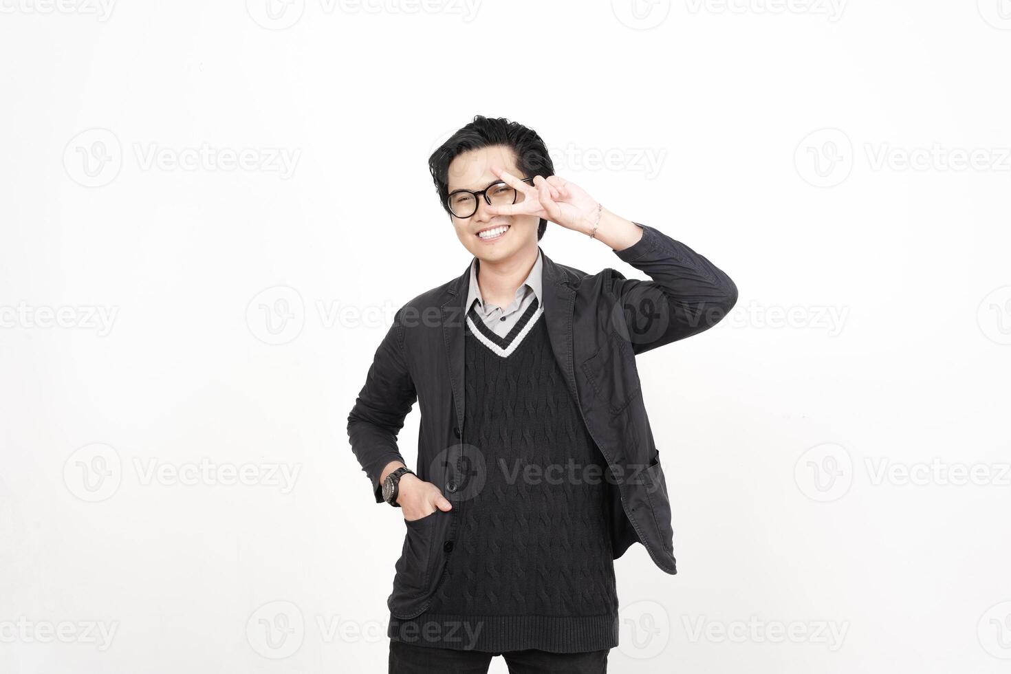 A man in glasses and a sweater is making a peace sign photo
