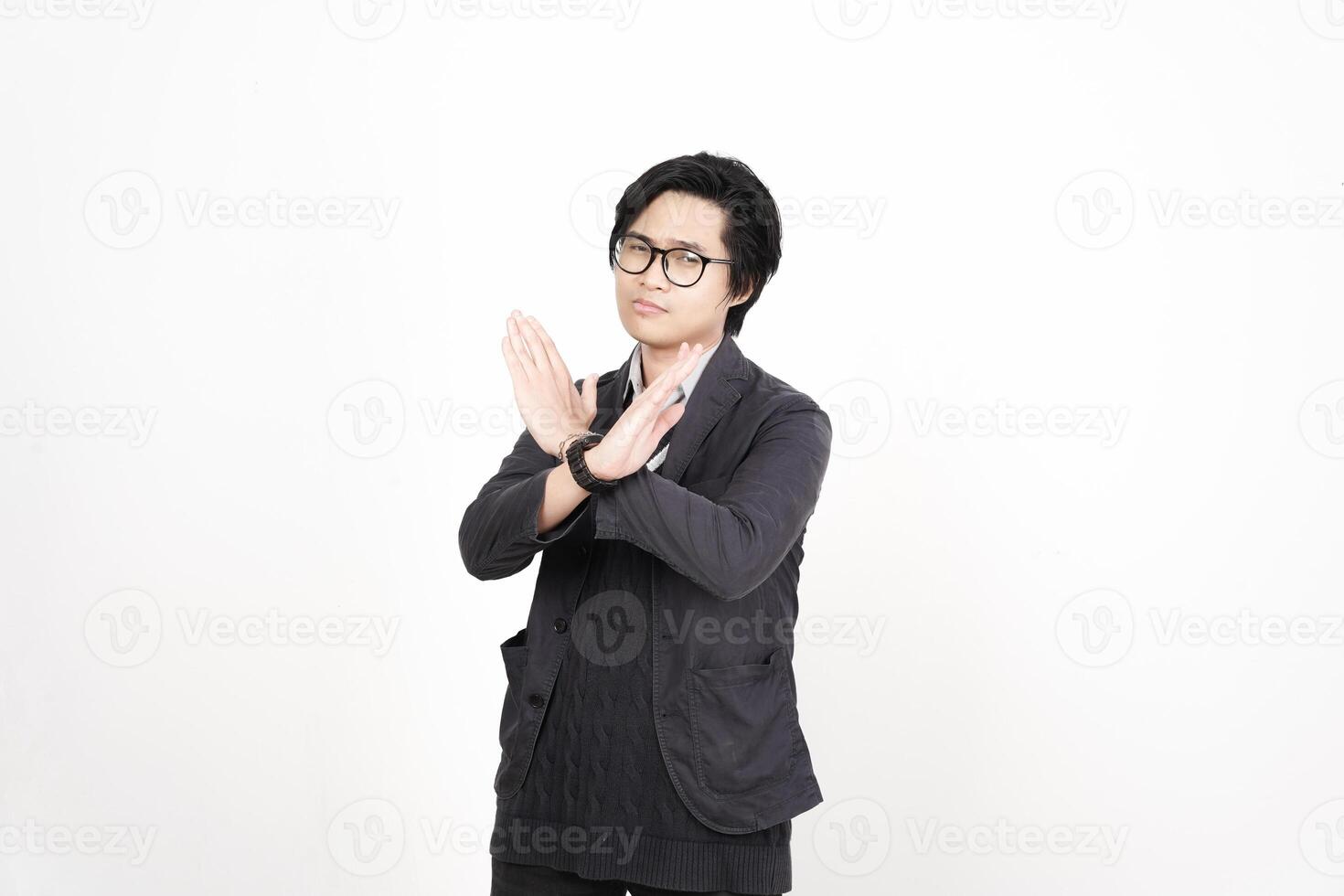 A man in glasses and a black jacket making a gesture photo