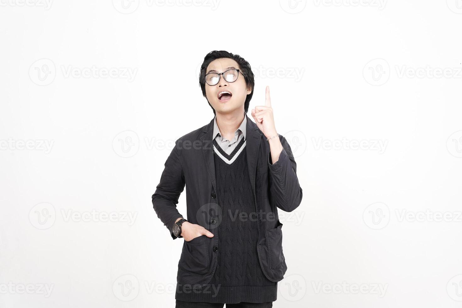 A man in glasses and a sweater is pointing to something photo