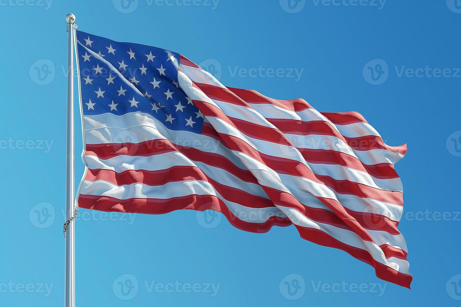 Flying high in the clear blue sky, a symbol of freedom and unity waves gently in the breeze. photo