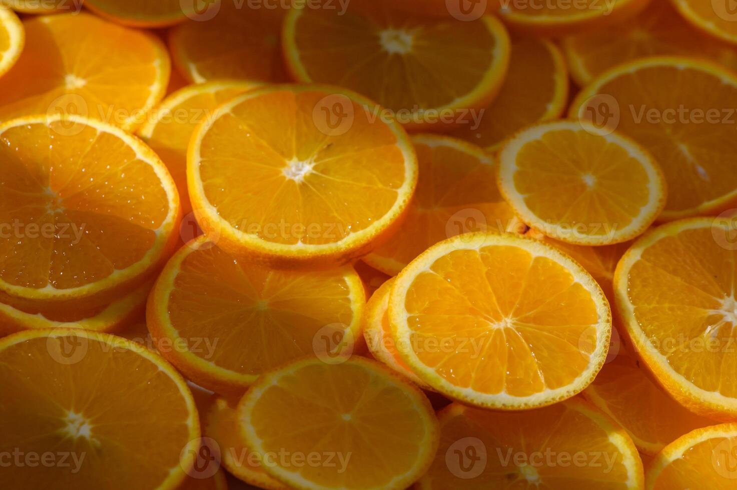 Fresh slices of vibrant oranges basking in sunlight in a lively kitchen setting photo