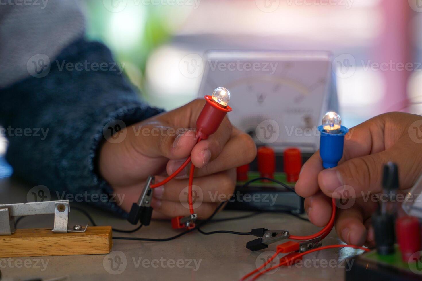 students are conducting experiments on basic electrical circuits. Concept of science classroom, learning, science skills, learning, science experiments. photo