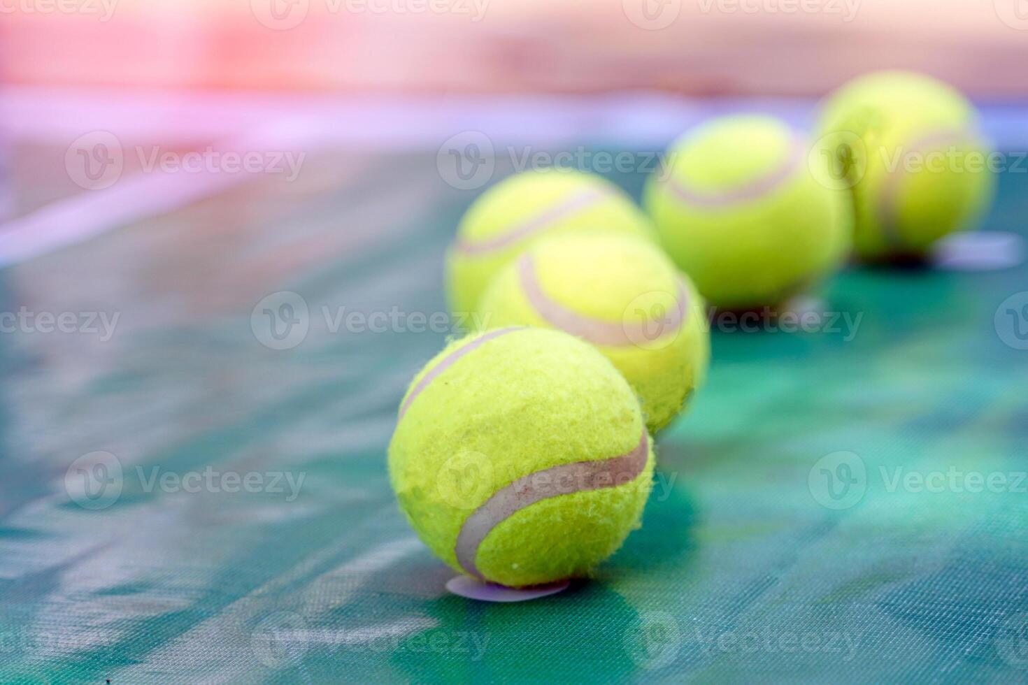 Tennis balls are arranged on a green background. Soft and selective focus. photo