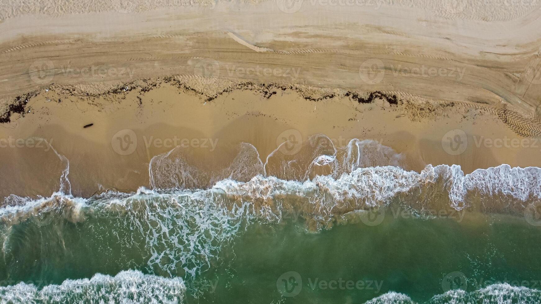 Top view horizontal beach and mediterranean sea with waves. Aerial view abstract coastline in summer. Marina di Ostui, Puglia, Italy photo